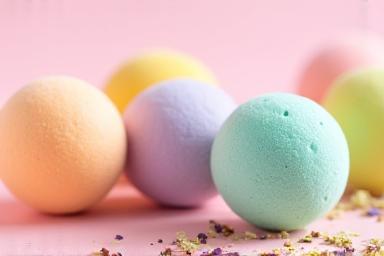 Colorful, spherical bath bombs with natural ingredients visible